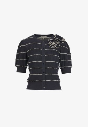 Black short-sleeve cardigan with horizontal white stripes, button front, and decorative fabric flower on the upper left shoulder.