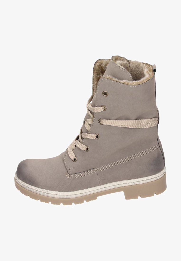 Botte d’hiver brun clair avec doublure en fourrure, col matelassé, devant lacé et semelle en caoutchouc texturée pour adhérence.
