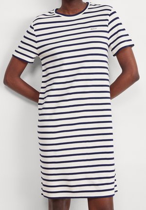 Gestreepte T-shirt jurk in wit en marineblauw, met korte mouwen, een ronde hals en een licht A-lijn silhouet. Logo op de borst.