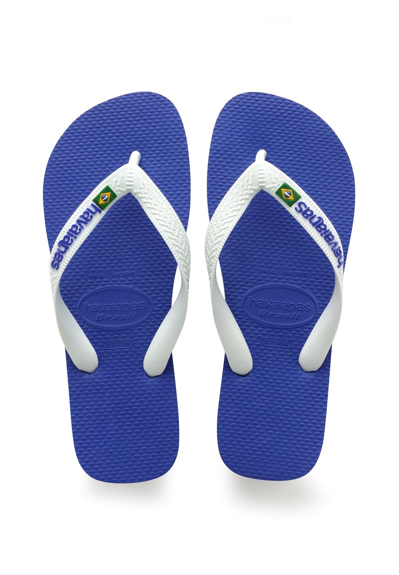 Sinine kummist plätud valgete rihmadega, millel on tekstuuriga tallad ja logo "havaianas Brasil" koos väikese Brasiilia lipuga.