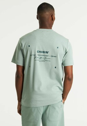 Lichtgroen T-shirt met korte mouwen met bedrukte tekst en vierkante accenten op de rug. Glad textuur, relaxed fit en ontwerp met ronde hals.
