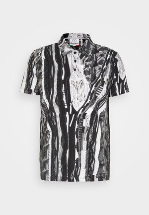 T-Shirt med korte ærmer, der har et sort og hvidt abstrakt mønster, lavet af letvægtsstof, med knaplukning foran og skjortekrave.