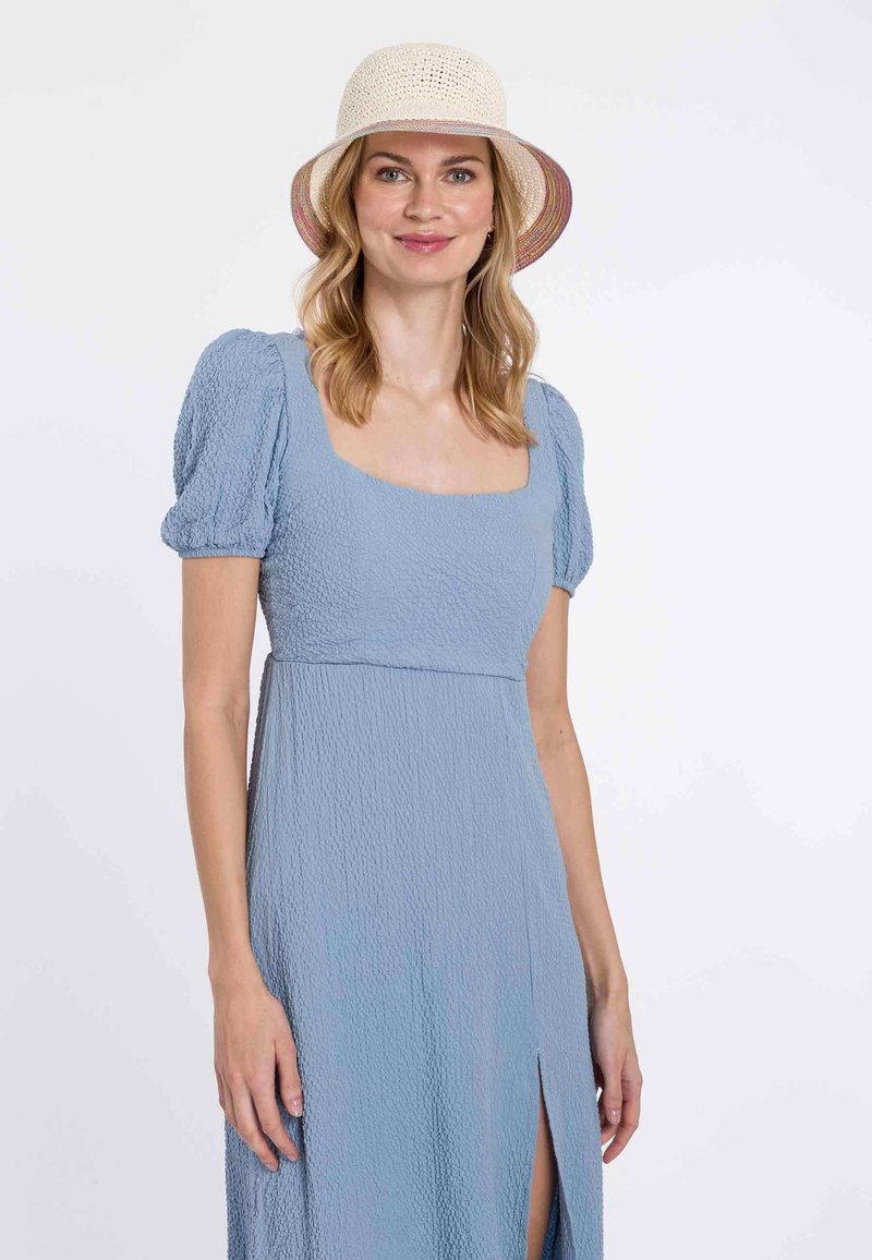 Light blue, textured, knee-length dress with puffed sleeves and a square neckline, featuring a side slit; paired with a straw hat.