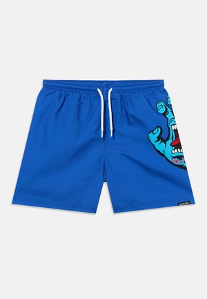 Blauwe zwemshorts met een witte trekkoord en een afbeelding van een blauwe hand met een open mond en een rode tong op het rechterbeen.
