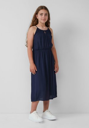 Navy blue sleeveless dress with a gathered neckline, cinched waist, and knee-length skirt. Paired with white sneakers.