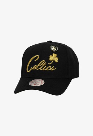 Black cap with a curved brim, featuring gold "Celtics" embroidery, a four-leaf clover detail, and a logo button on the front.