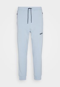 Light blue jogger pants made of soft cotton blend, featuring an elastic waistband with drawstring, side pockets, and a black logo on the thigh.