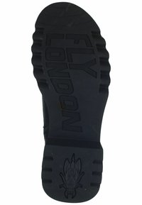 Black rubber shoe sole with deep grooves, featuring embossed text “FLY LONDON” and a fly logo, providing durable traction and grip.