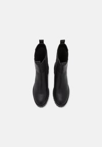 Mustat nilkkurit, jotka on valmistettu sileästä nahasta, pyöreällä varpaalla, tyylikkäällä muotoilulla, joustavilla sivupaneeleilla ja vetonauhoilla ylhäällä.