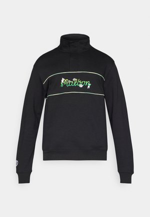 Musta korkeakauluksinen collegepaita, jossa rintakehän alueella vihreää ja valkoista kirjailua sekä kukka-aiheisia koristeita. Hihansuissa resorit.