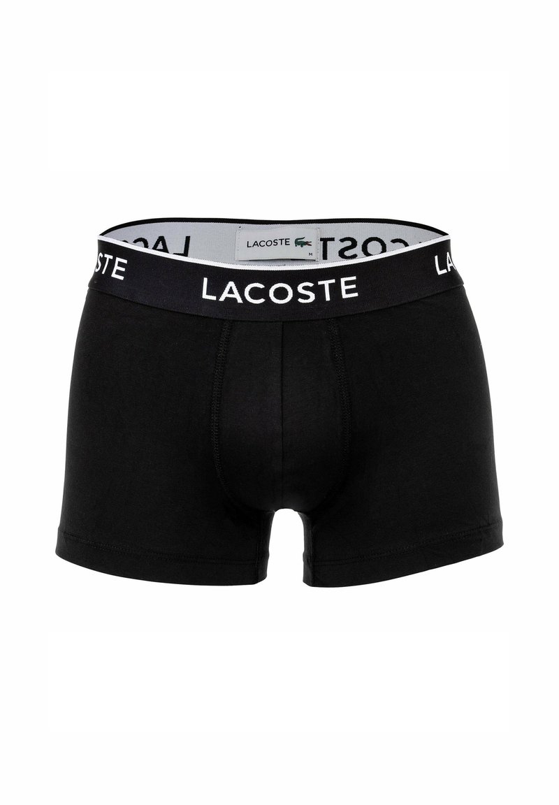 Schwarze Baumwoll-Boxershorts mit einem breiten schwarzen Bund, der das "LACOSTE"-Logo in Weiß trägt. Entworfen mit einer enganliegenden Passform und einem Vorderpouch.