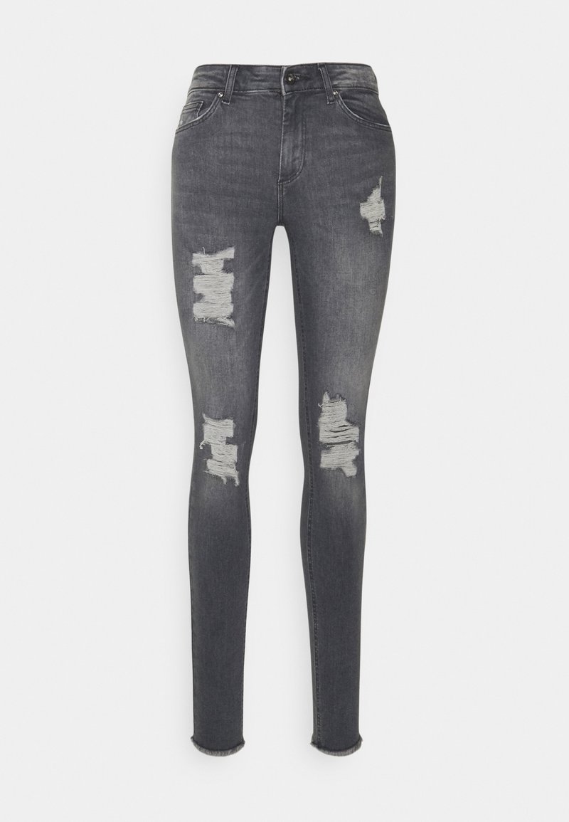 Jeans ajustados en denim gris oscuro con desgastes, que presentan detalles rasgados en las rodillas y un dobladillo sin rematar en el tobillo.