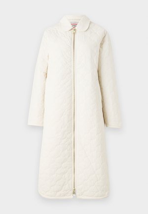 Quilted, knee-length coat in off-white. Features a collar and a front zipper closure. Smooth texture with a subtle pattern.
