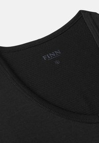 Black sleeveless top with a textured, honeycomb-patterned fabric and a wide neckline. Features “FINN” logo printed in dark blue on the back.