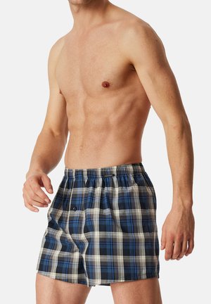 Checkered boxers featuring blue, white, and gray plaid design. Elastic waistband with a button detail. Lightweight, breathable fabric.
