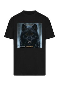 Black cotton t-shirt featuring a graphic of a fierce black wolf with yellow eyes, text overlay "Trust your instincts" and "be fearless!"