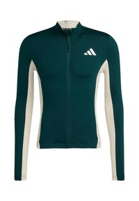 Langärmlige, athletische Zip-Jacke in dunklem Teal mit cremefarbenen Seiteneinsätzen. Sie verfügt über einen Stehkragen und das adidas-Logo auf der Brust.