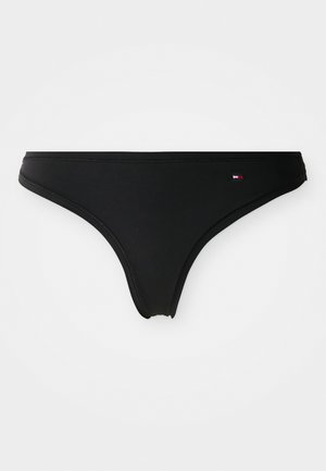 Black bikini brief made of smooth fabric. Features a low-rise cut with a thin waistband. Small branded accent in red, white, and blue on the side.