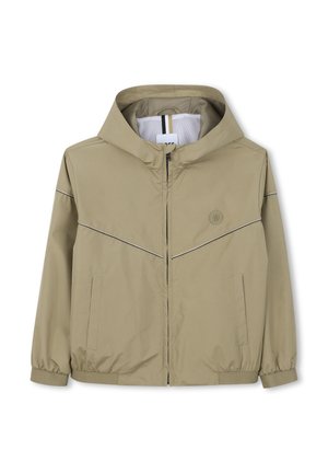 Veste à capuche beige clair avec fermeture éclair sur le devant, deux poches latérales, poignets élastiques et logo discret sur la poitrine sur fond blanc.