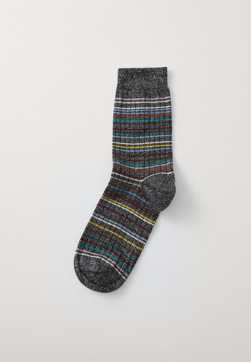 Striped sock featuring a black base with multicolored lines in green, yellow, and red. Textured ribbing throughout.