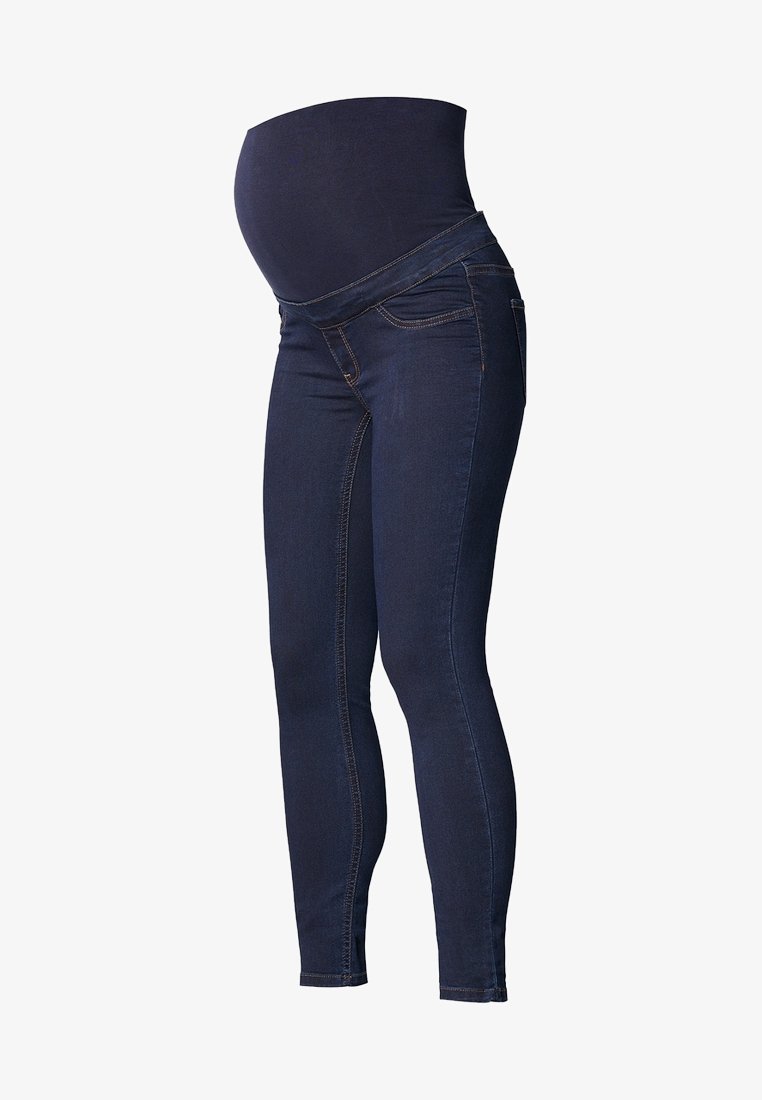 Schwangerschafts-Skinny-Jeans aus dunkelblauem Denim. Verfügt über einen elastischen Bund und flache Nähte für mehr Komfort. Entworfen für eine figurbetonte Silhouette.