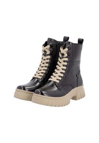 Bottes chelsea en cuir noir avec lacets crème, fermeture éclair sur le côté et semelle épaisse beige, présentant une finition lisse et des détails de couture renforcée.