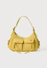 Yellow suede handbag with two front pockets, adjustable strap, and detailed stitching. Features a zippered pocket and metal accents.