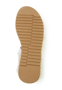 Rubberen zool van een sandaal met een getextureerd oppervlak met horizontale groeven. Kleur is tan, met een zichtbare maat aanduiding "39."