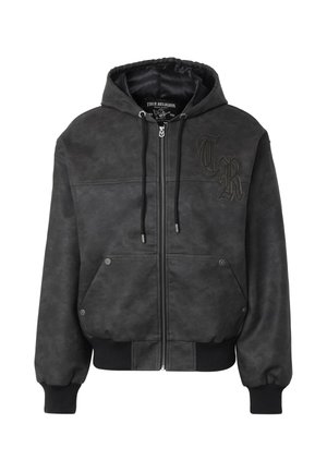 Veste à capuche noire zippée avec poches avant, poignets et ourlet côtelés, cordons de serrage et logo décoratif "TR" sur la poitrine gauche.
