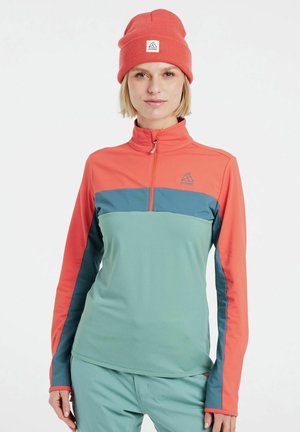 Priliehavý top s dlhým rukávom v koralovej a smaragdovej farbe, s doplnkom na zips a farebným blokovým dizajnom. Vyrobený z hladkej, elastickej tkaniny.