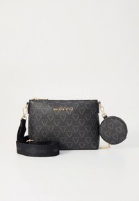 Black, textured leather crossbody bag with gold hardware, featuring a logo design, adjustable strap, and a detachable round coin pouch.
