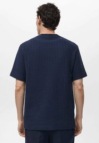 Kortekorte mouw navy blauwe geribbelde t-shirt met een ronde halslijn en textuurstof, met een relaxte pasvorm en minimale details op de rug.