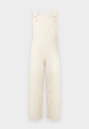 Cream-colored wide-leg overalls with front bib, adjustable shoulder straps, and subtle decorative stitching.
