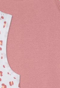 Two pieces of clothing: a pink tank top and a white top with a colorful abstract pattern. Both have soft, smooth textures.