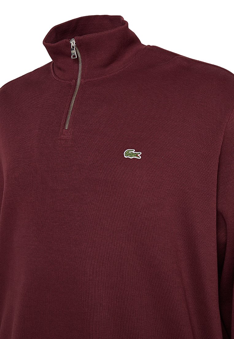Bordeaux kwart-rits trui met een ribbeltextuur, voorzien van een klein groen en wit geborduurd krokodillogo op de borst.