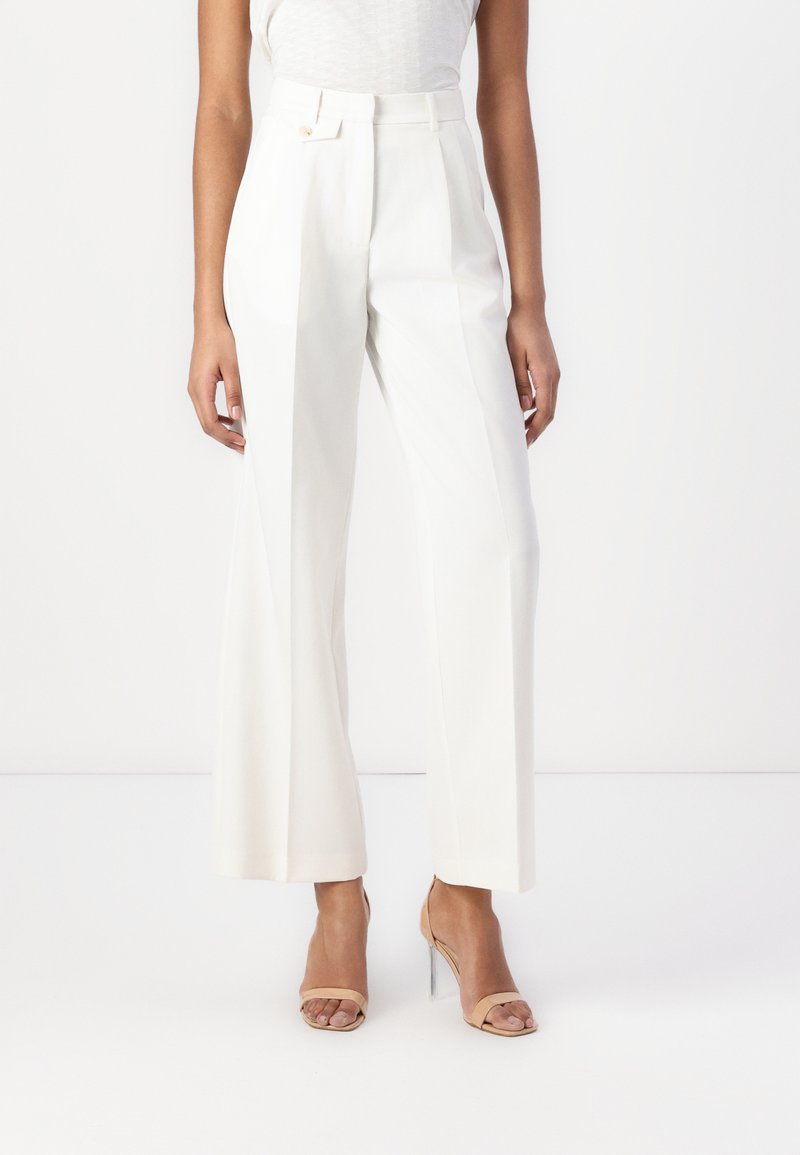 Pantalons larges blancs à taille haute, dotés d'une fermeture à un bouton et d'un tissu lisse. Style simple et ajusté.