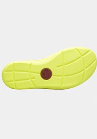 Bright yellow outsole with textured grip pattern, featuring a circular brown emblem labeled "38," designed for traction and durability.