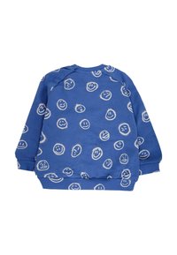 Sweatshirt bleu présentant une variété de motifs de visages souriants en blanc. Poignets et col côtelés, avec des boutons-pression sur une épaule.