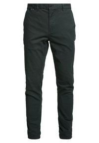 Tmavě zelené, slim fit kalhoty z bavlny. Mají zapínání na knoflík, kapsy a hladký povrch. Vhodné pro běžné i poloformální nošení.