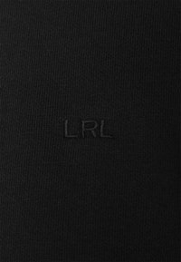 Black knit fabric featuring a subtle "LRL" logo, textured surface, and consistent yarn pattern across the material.