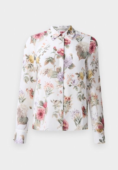 Blumenbluse mit langen Ärmeln, Knopfleiste und weißem Hintergrund. Verziert mit rosa, lila und gelben Blumen auf einem leichten Stoff.