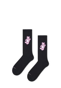 Czarne bawełniane skarpetki o ribbowej teksturze, z różowym wzorem misia na boku. Proste, do kolan, z kontrastującymi kolorami.