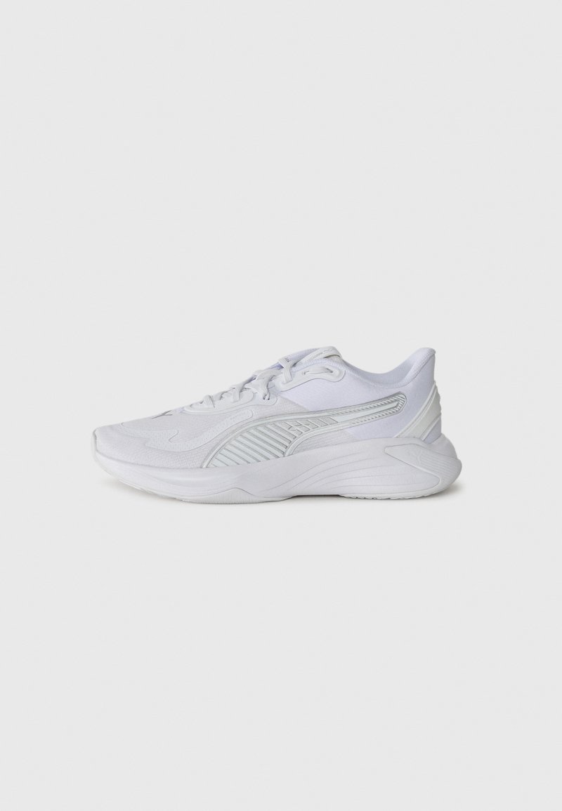 White athletic shoes with a textured upper, striped accents, and a cushioned sole. Features laces and a rounded toe design.
