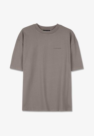 Šedé krátke tričko s krátkym rukávom vyrobené z mäkkej bavlny. Má okrúhly výstrih a jemne vyšívané logo vpredu. Voľný strih.
