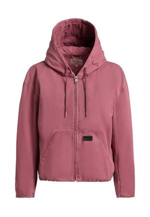 Vaaleanpunainen vetoketjullinen huppari, jossa on etutaskut ja kiristysnauhat sekä pieni musta merkki vasemman taskun alueella.