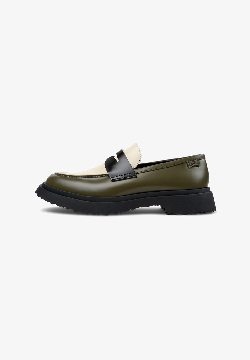 Green and cream leather loafer with a black strap, a textured sole, and a rounded toe, featuring a smooth finish and contrasting colors.