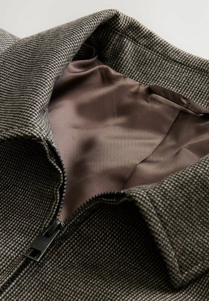 Gray, textured jacket with a black zipper and brown lining. The collar is folded, revealing the smooth interior fabric.
