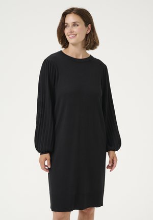 Abito nero con una vestibilità comoda, caratterizzato da maniche lunghe a costine, scollatura a girocollo e orlo dritto. Realizzato in morbido tessuto a maglia.