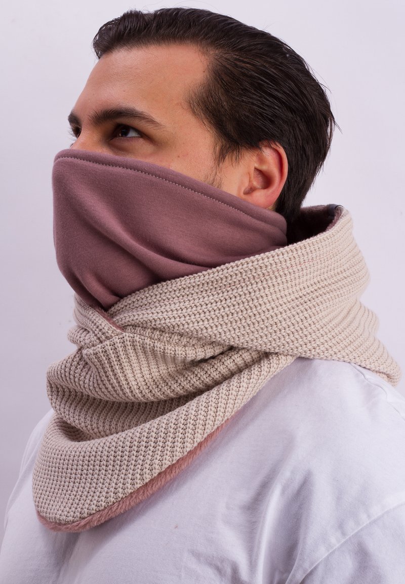Beige knitted scarf with a light pink inner layer, soft texture, and seamless design, wrapping around the neck and covering the lower face.