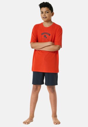 Red cotton t-shirt with a blue "SOUTH BEACH" motif and palm graphic, paired with navy shorts. The t-shirt has short sleeves and a round neckline.